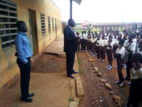 The school principal addressing his students