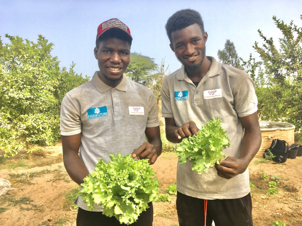 On the job: showing off their first produce!