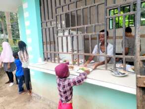 Adolescent serving kids food