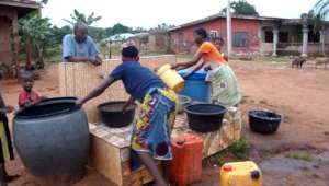 Residents store water in drums