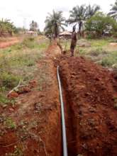 workers laying underground water extension pipes