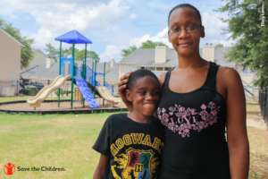 Mother and son pose in front of a playground in TX