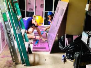 A site supervisor cuts styrofoam insulation