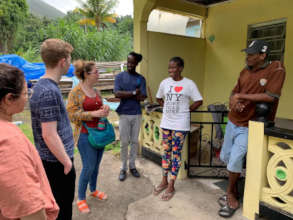 Emma (far left) visits local Dominican beekeepers.