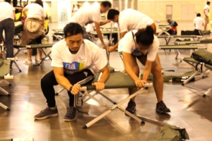 Volunteers assemble cots before the shelter opens.
