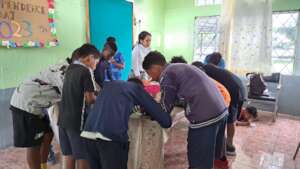 Children preparing a gift for their friends.