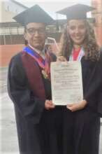 Maria with a professor during graduation