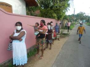 Queuing families waiting for food parcels