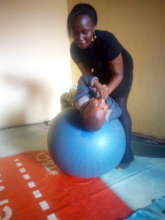 A child receiving therapy on the therapy ball