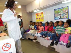 Children get a check-up in the Colgate dental van