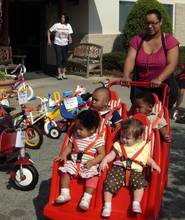 Babies enjoy the ride at the Walk-a-Mile