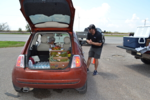 Filling up trunks with food assistance.