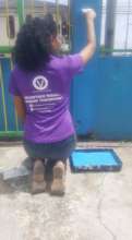 Volunteer Painting at Kids In Need of Direction