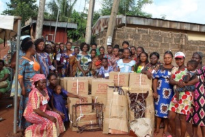The trained women pose with the Sewing machines