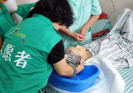 Volunteers helping patient with basic care