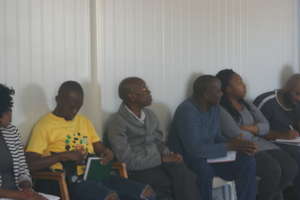 men at community dialogue