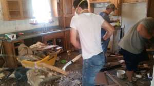 A mucking crew working on the house from the...