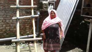 Beneficiary 2- In front of her house