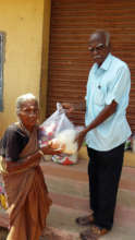 Neglected elder eagerly receiving food groceries