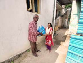 Blind girl receiving food groceries and clothes