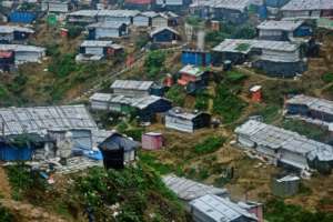 Shelters sit precariously on a hillside.