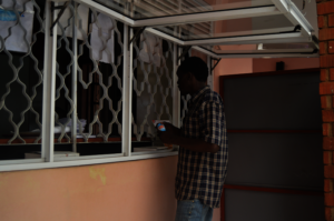 Aggrey picks his ART refill from AMS' pharmacy.