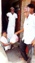 Polio affected girl receives food groceries.