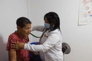 One of our doctors examining an elderly person