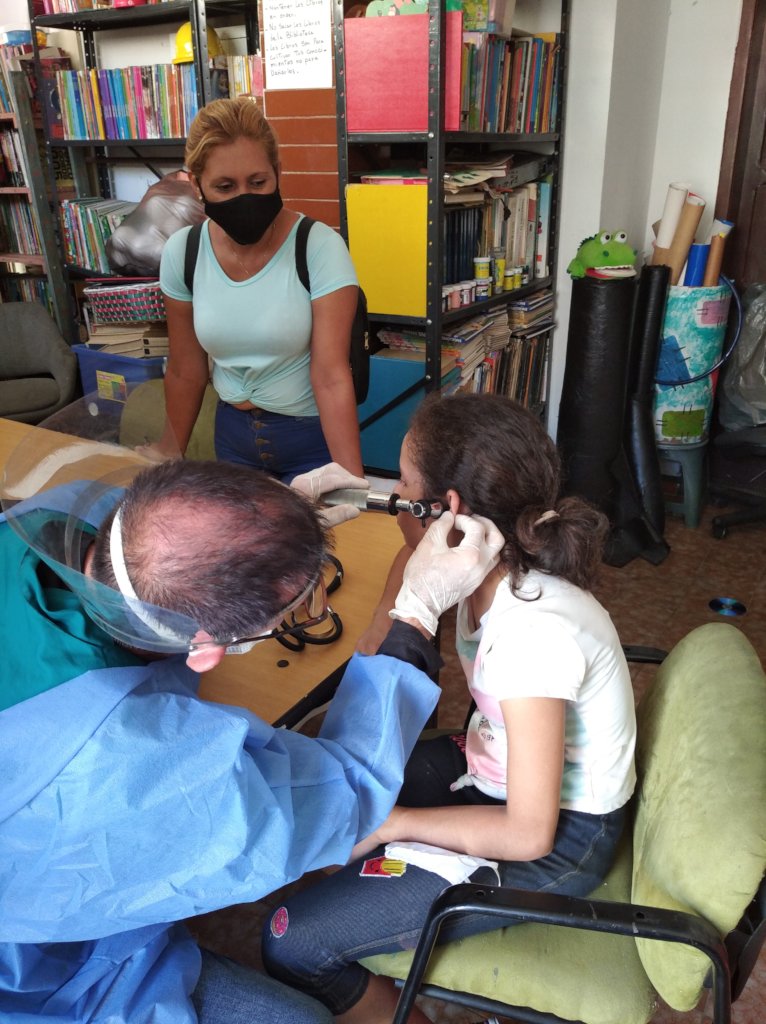 SAI medical Doctor examines orphan girl's ears.