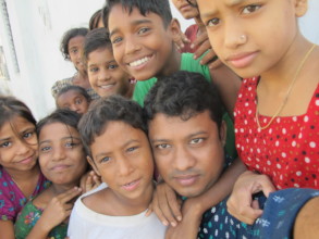 Social worker Tanjil with the school children