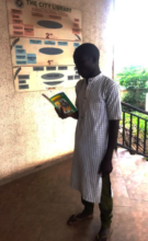 Muazu reading for fellow Almajiris