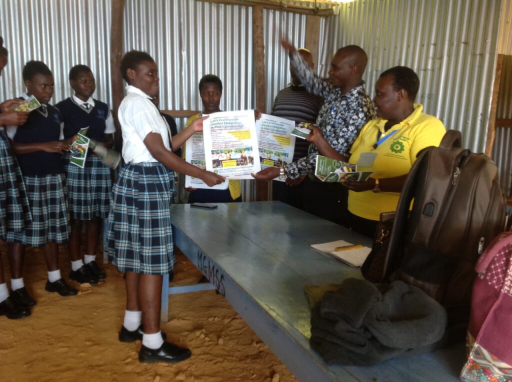 Gladys issues FGM learning materials to the girls