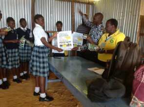 Gladys issues FGM learning materials to the girls