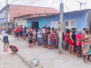 Community members lining up for meals