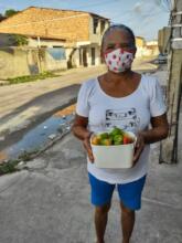 A woman receiving fresh vegetables