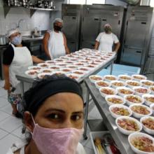 Regiane & others preparing meals in the kitchen