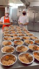 Regiane & her son with some of the prepared meals