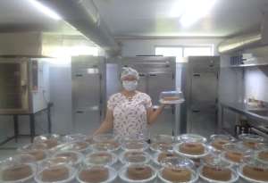 Carlenia with cakes she made for hungry families