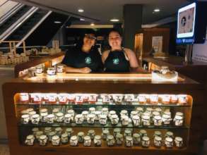 Ana Paula and Mariane showing off products at mall