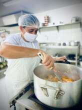 a student hard at work preparing community meal