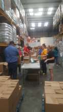 Volunteer group assembling 3,000 family food boxes