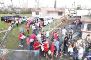 Volunteers dispatch food to community members