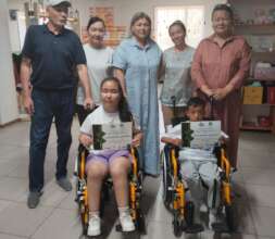 Aighul and Abrorbek in their new wheelchairs