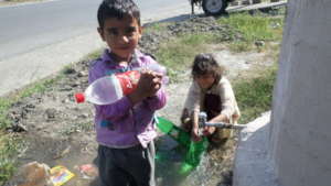 Children getting water from the well tap