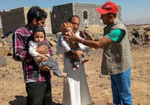 Relief International staff check for malnutrition.