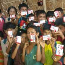 Holding their new bars of soap