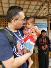 Dr. Wasty with a baby in the Rohingya camps