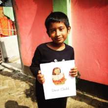Student holding a "Dear Child" Book