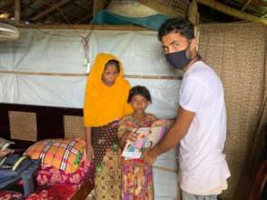 Rohingya child receiving books