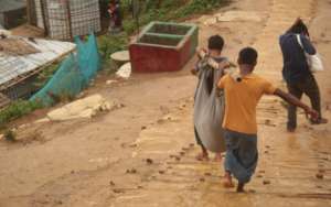 Porters taking clinic patient to OBAT Ambulance